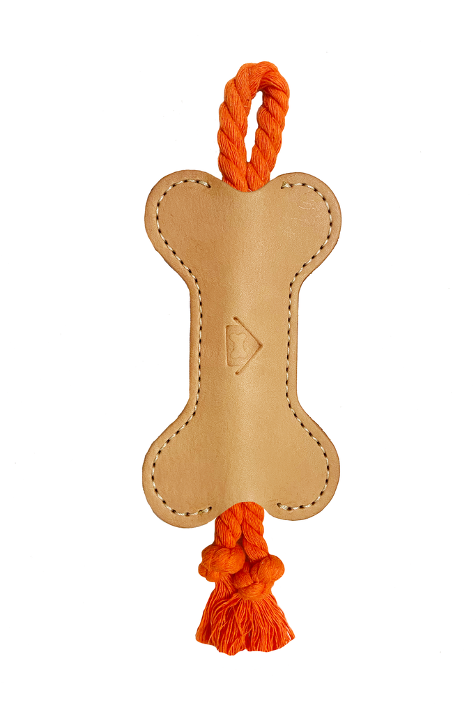 orange colored vegetable leather tug toy, full view