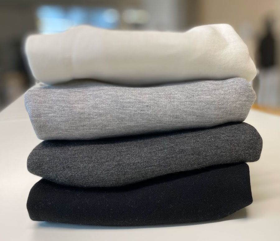 stack of Unisex Hoodies in different colors